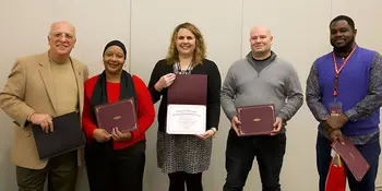 Five people holding RISE awards