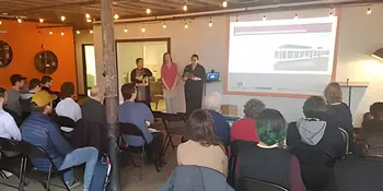 Students Nora Steppe, Jennifer Webb and Farra Lomasney standing in front of an audience.