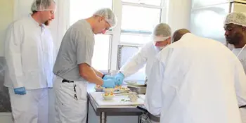 Four men working in a kitchen