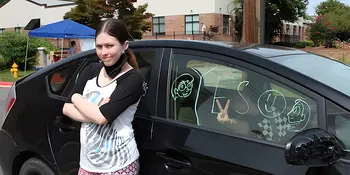 Gabriella Kusz stands next to her mother's car