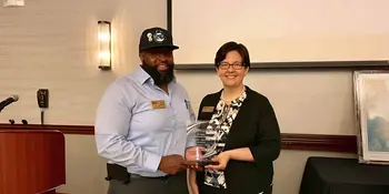 Philip Cooper and Shelley White holding CCA Award