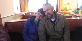 Man and women sitting close together smiling