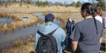 Helen Burrell and students at retention pond